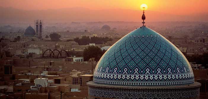 Sunset inflames the crescent symbol atop the dome of the Jame Masjid. ©Michael Yamashita